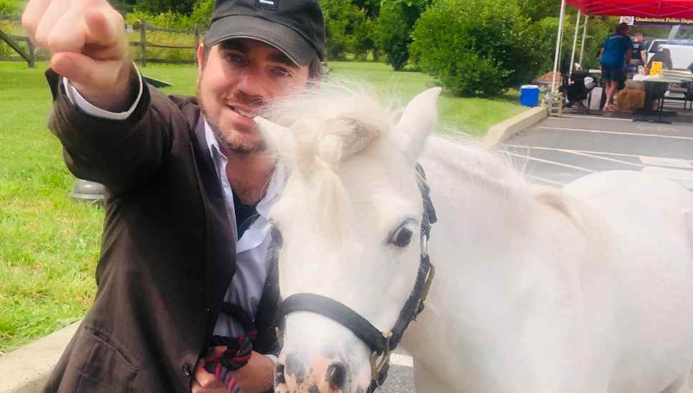 man with small horse