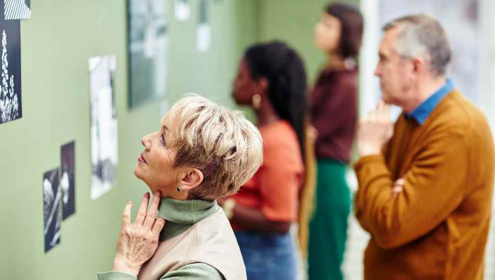 people looking at a green wall