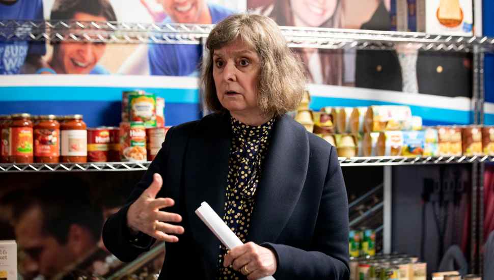 woman holding rolled up paper