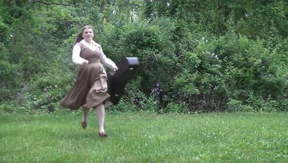woman running with a guitar