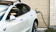 Tesla Model 3 charging at home in front of the house.