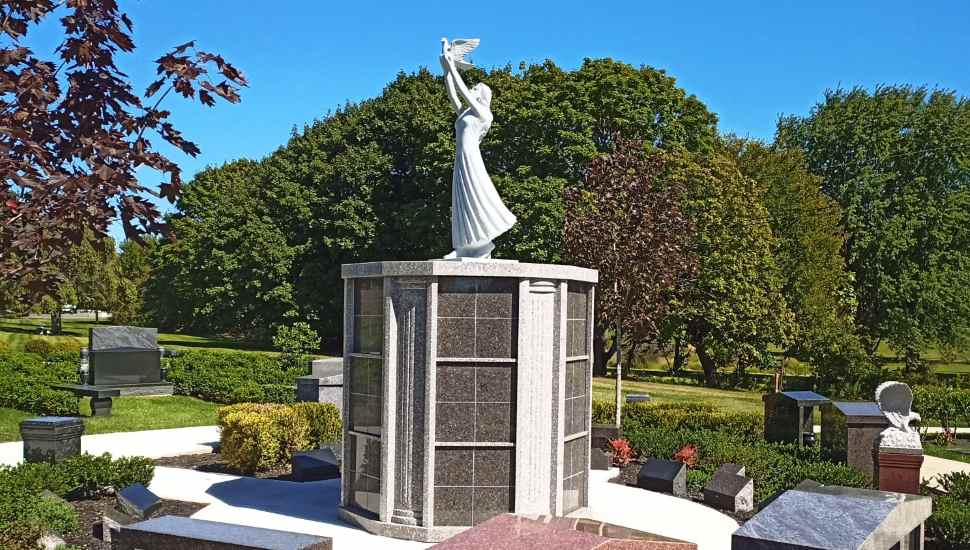 statue of an angel with dove