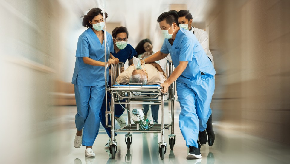 medical staff running with gurney