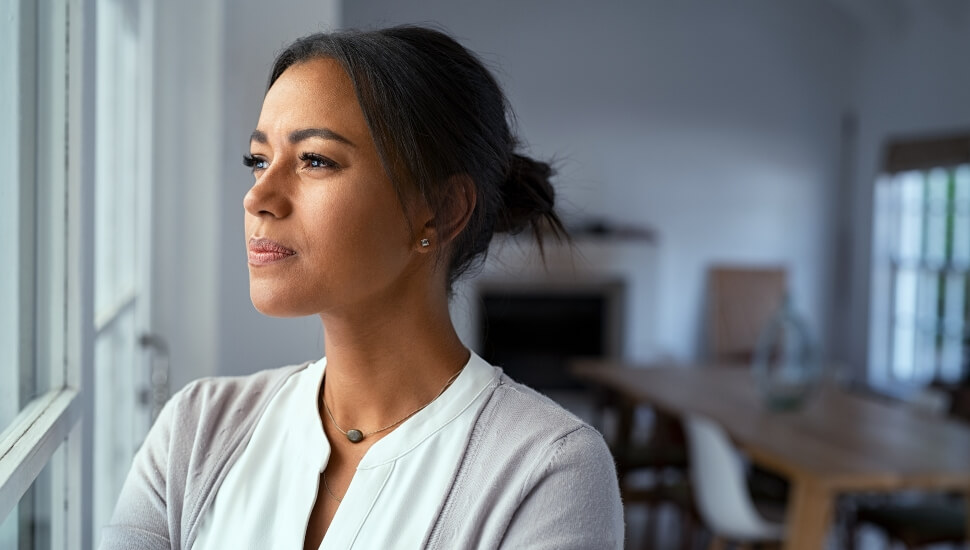 A woman looking out the window deep in thought