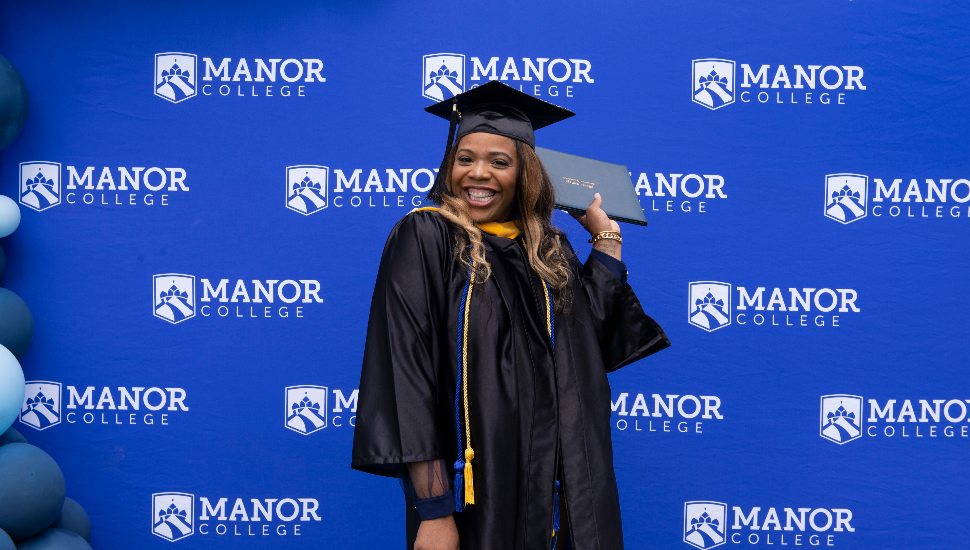 smiling woman in cap and gown