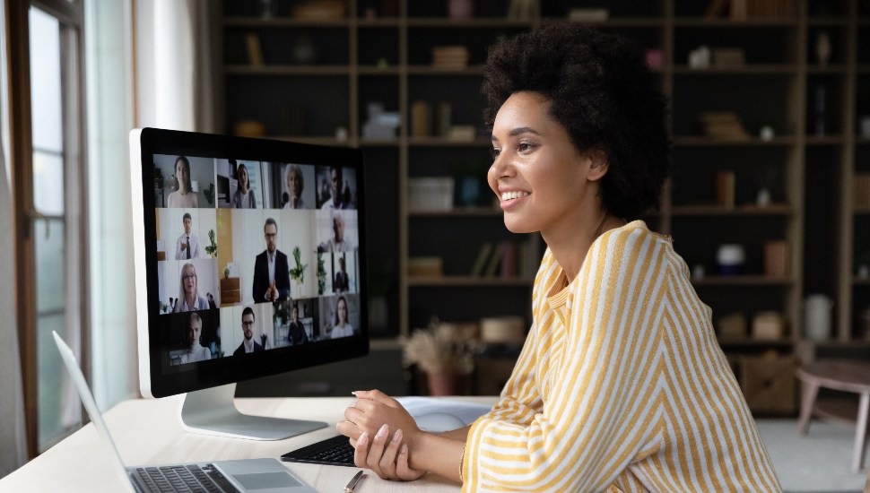 smiling woman in front of screen