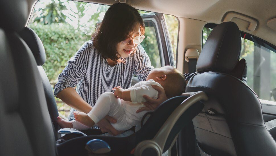 woman with baby in car