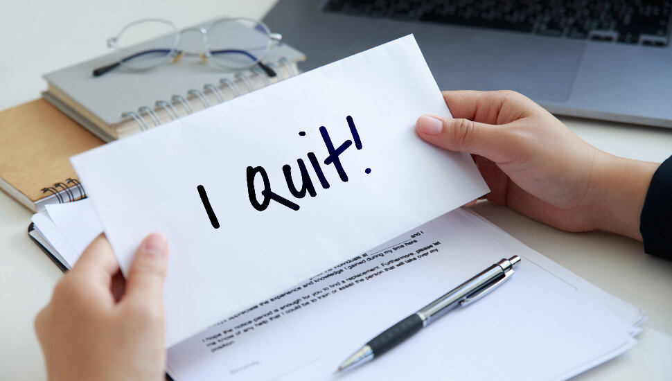 Man holding I quit resignation letter