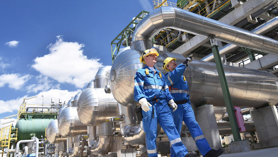Men walking an oil refinery