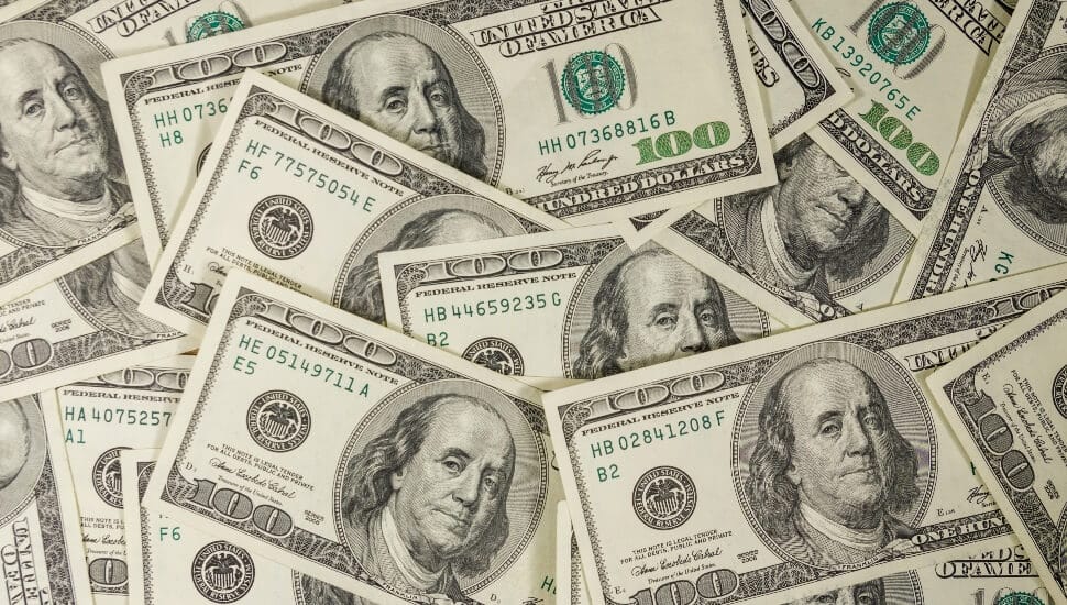 Hundred Dollar bills laid on a table