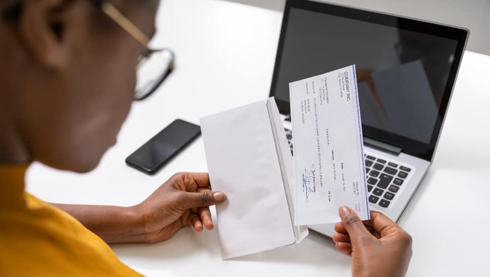 Young woman looking at her paycheck