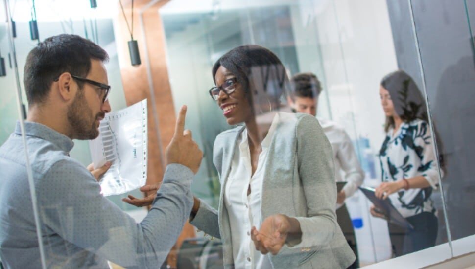 Angry boss with upset face pointing his finger up to female employee making a mistake in business project. Angry boss, frustrated, upset, mistake, fired job concept.