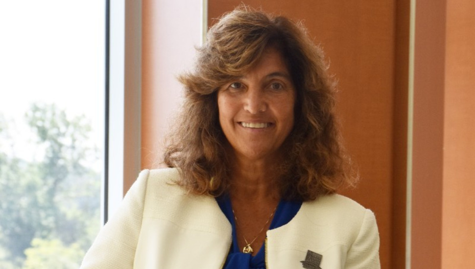 smiling woman in white blazer