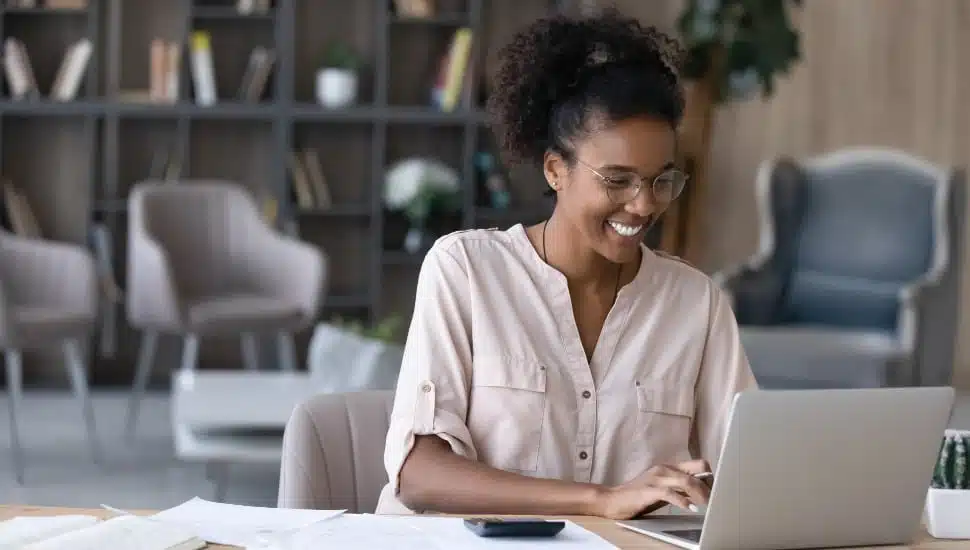 woman smiling at computer high paying job