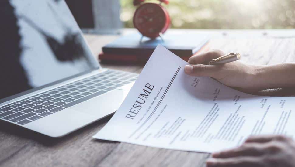 Business man review his resume application on desk