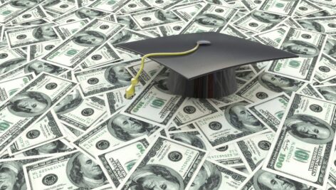 Mini graduation cap on US money