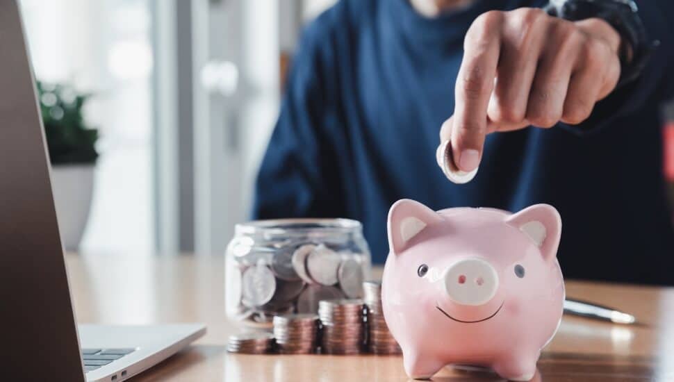 Man putting money in a piggy bank