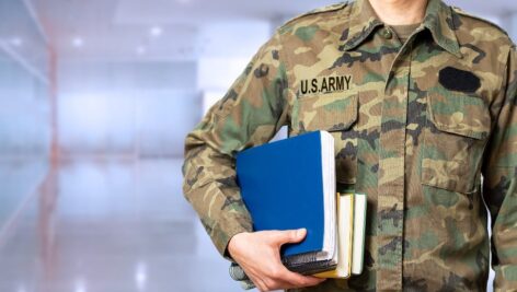 Soldier uniform man holding books school hallway