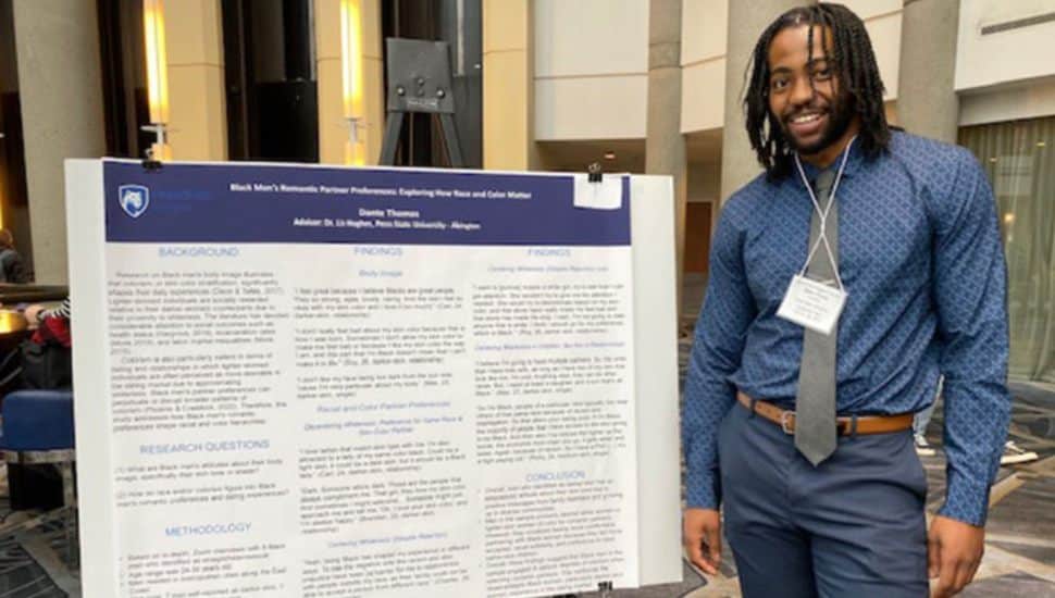Dante Thomas in front of data board