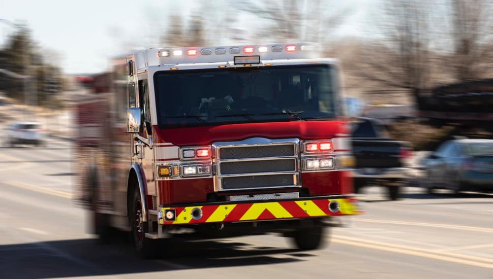 A firetruck driving on a public road