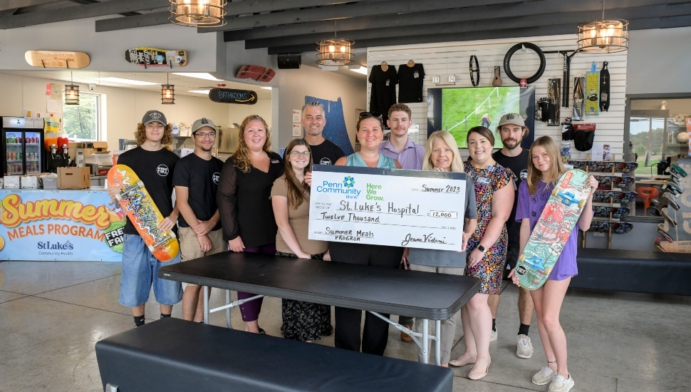 Penn Community Bank gives St. Luke's a donation.