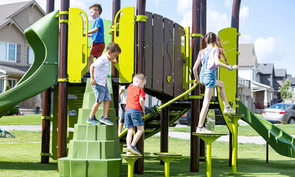 Boys and girls playing on playground equipment .
