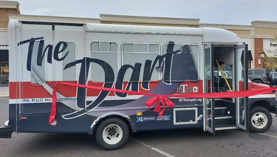 A DART bus with a red ribbon on it.