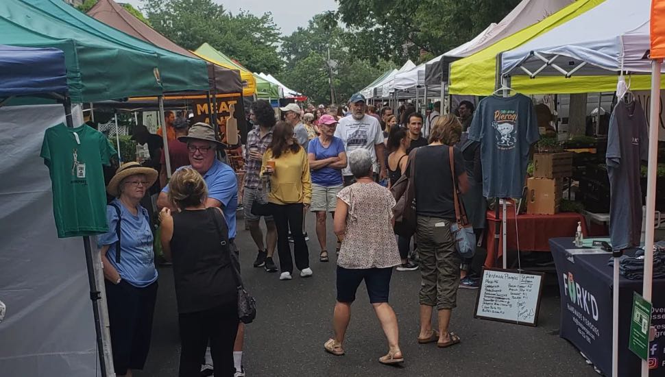 People shopping at an outdoor farmers market