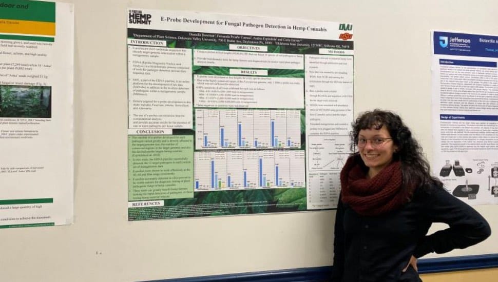 Professor Danielle Bowman standing next to a chart