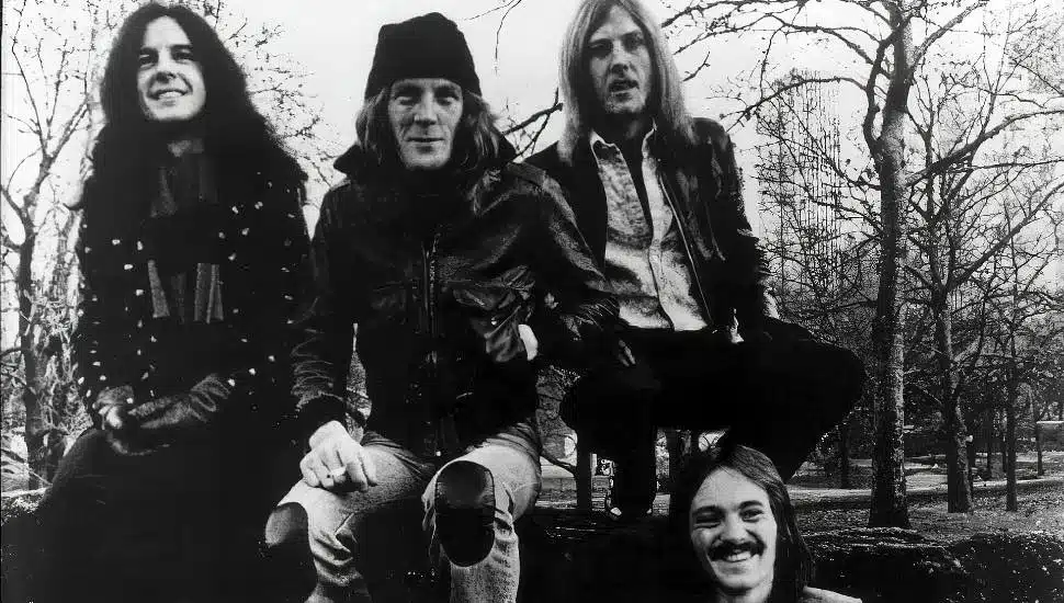 Four members of Humble Pie sitting outside.