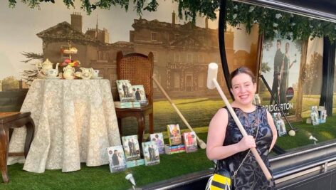 Author Julia Quinn stands in front of "Bridgerton" merchandise and books