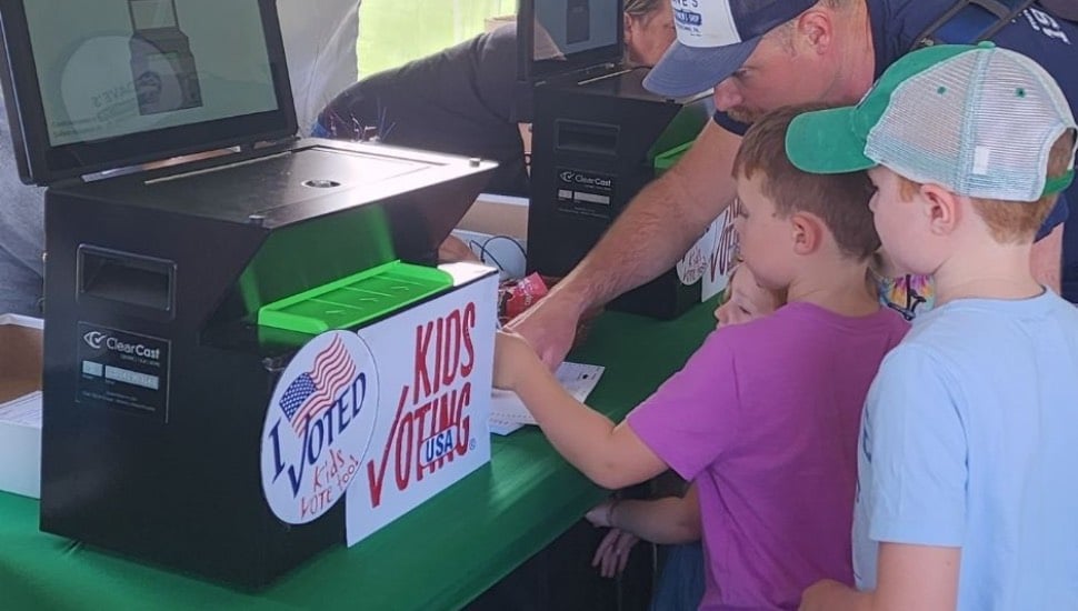 Children at a voting machine.