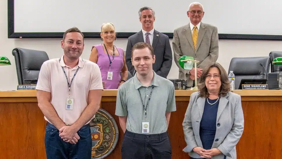 Several people standing in a court room
