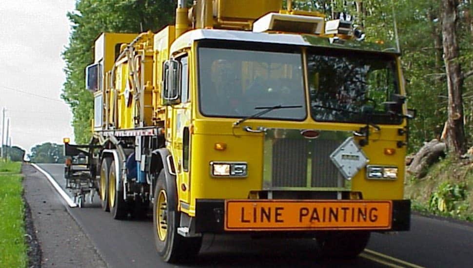 A PennDOT truck painting lines on a road