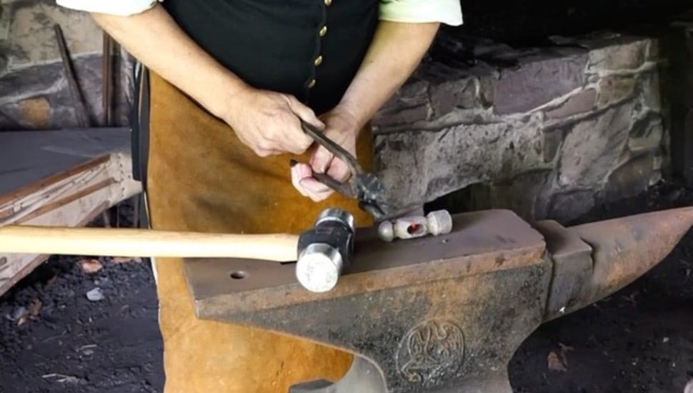 A man working on an anvil