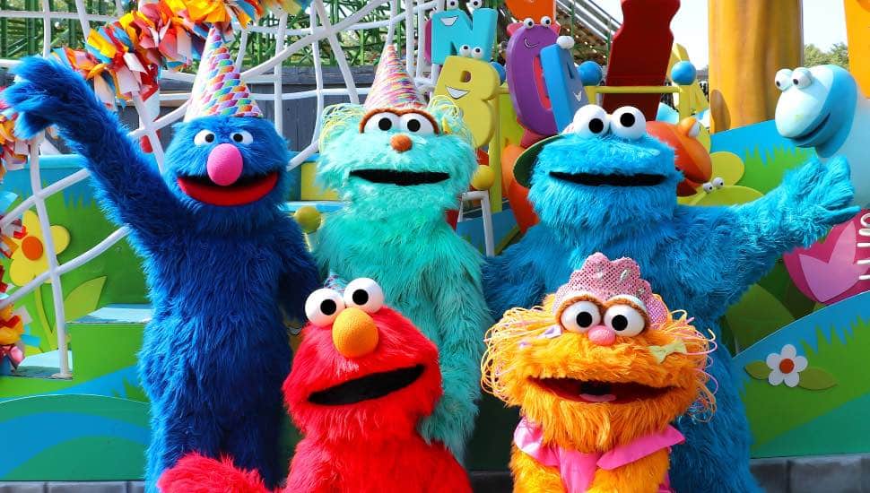 Several Sesame Street characters in party regalia