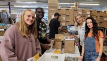 Several volunteers packing boxes for the nonprofit