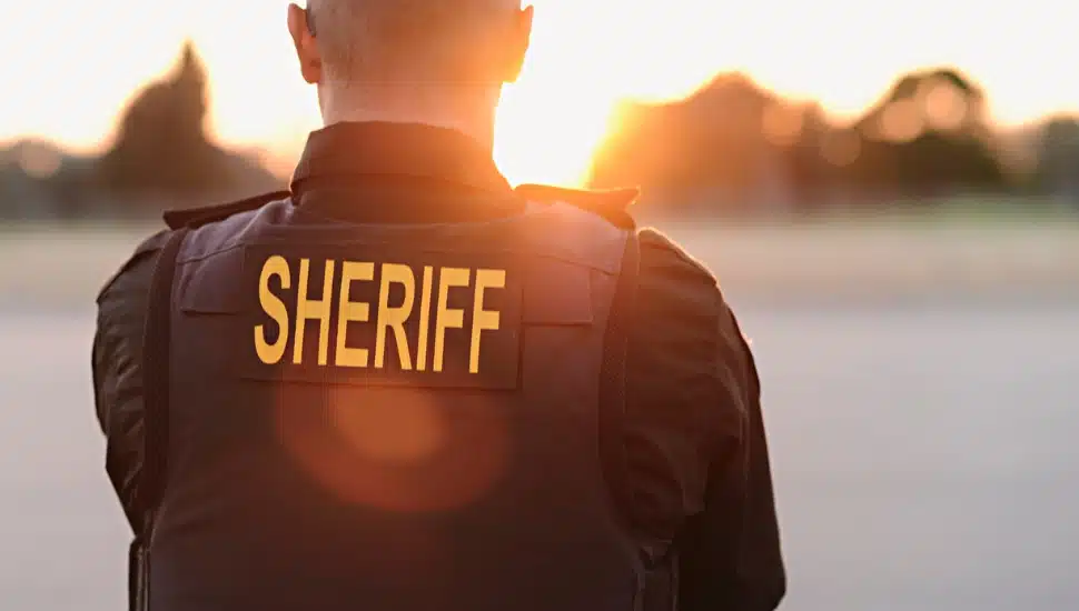 A sheriff looking into a sunset