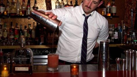 A bartender pouring a drink.