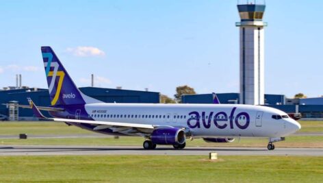 An Avelo Airlines plane taxis on a runway.