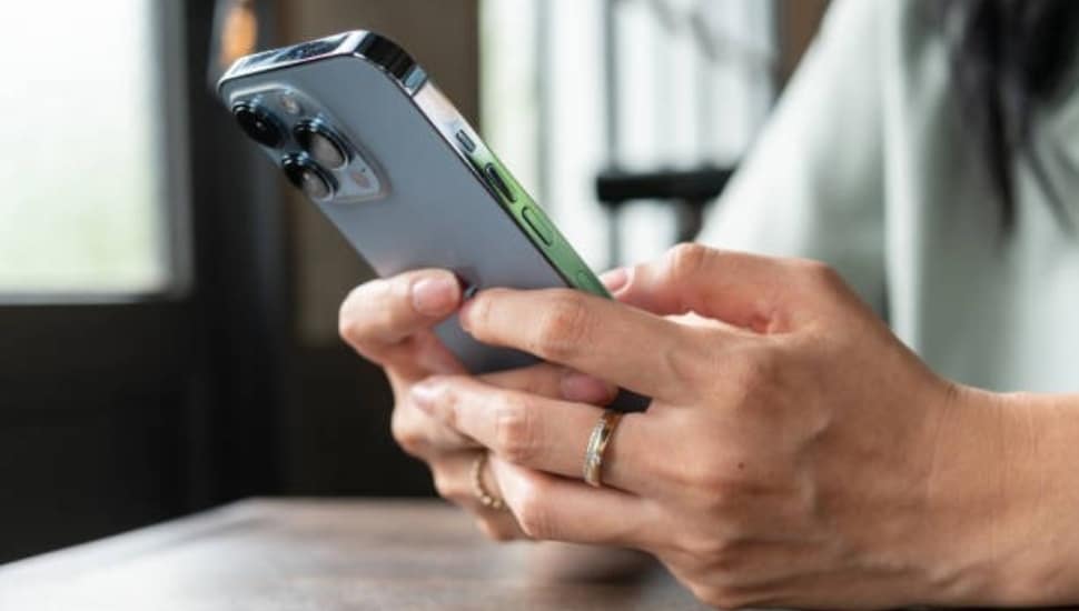 A woman's hands holding a cell phone