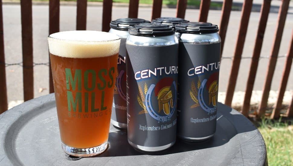 A glass and several cans of Centurion Ale.