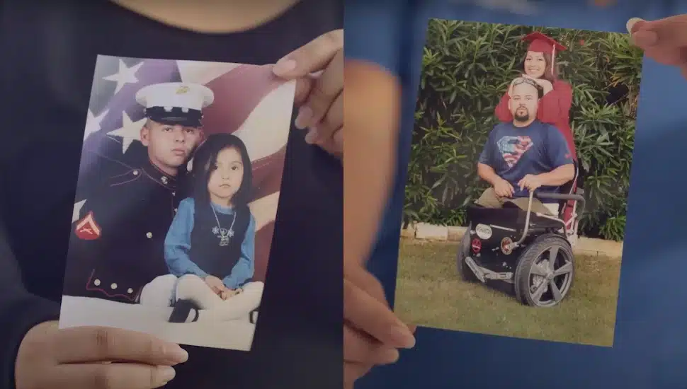 A woman holds a picture of her father