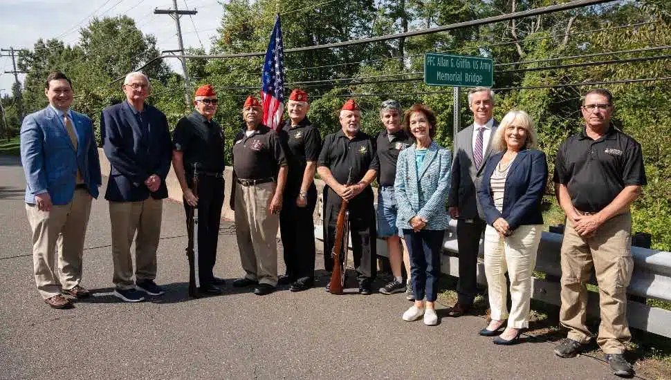 Members of the Bucks County Government stand by a bridge