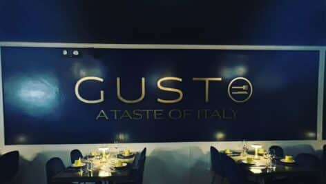 A sign for Gusto Ristorante Italiano BYOB