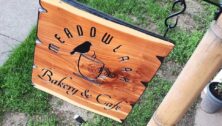 A wooden sign for Meadowlark Bakery & Café