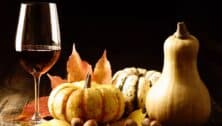 A glass of wine with pumpkins