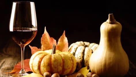 A glass of wine with pumpkins