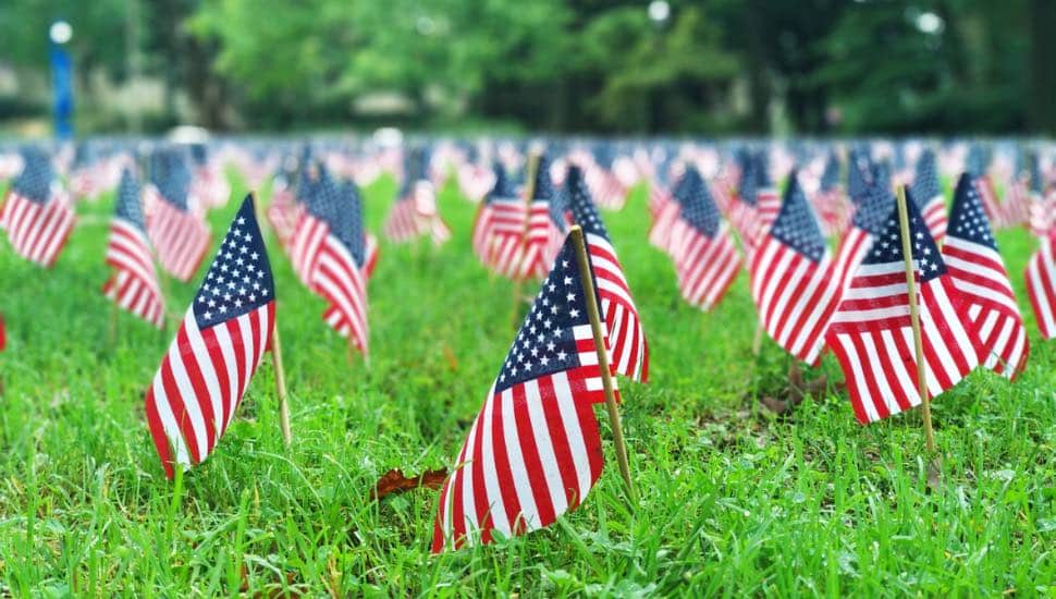 Small flags left in the grass for 9/11 victims