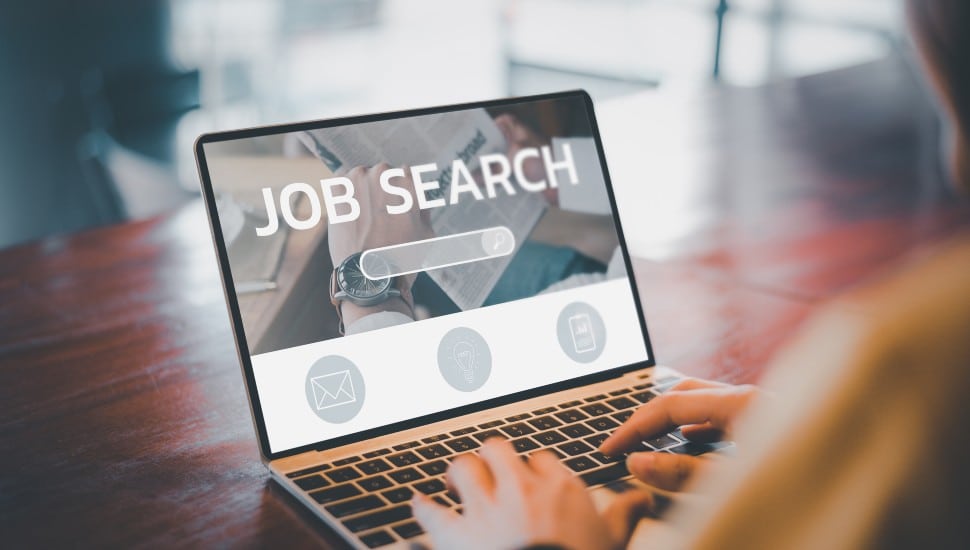 A computer with a screen that reads "Job Search"